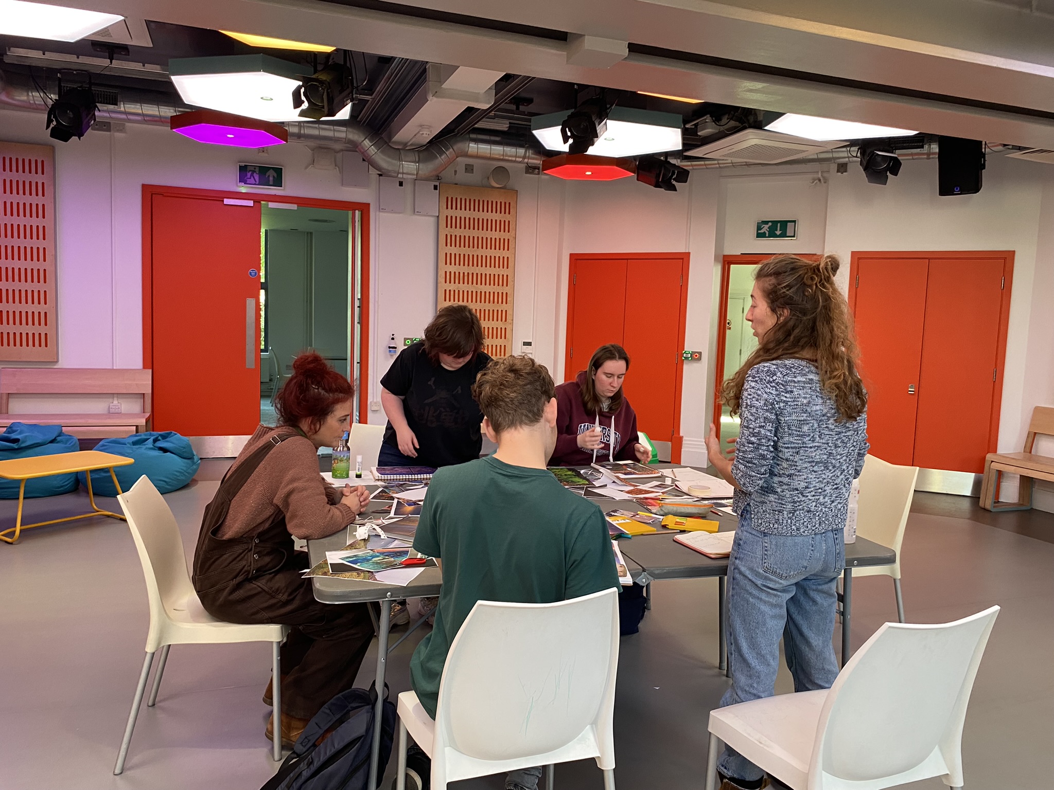Team of young people working on project around the table together