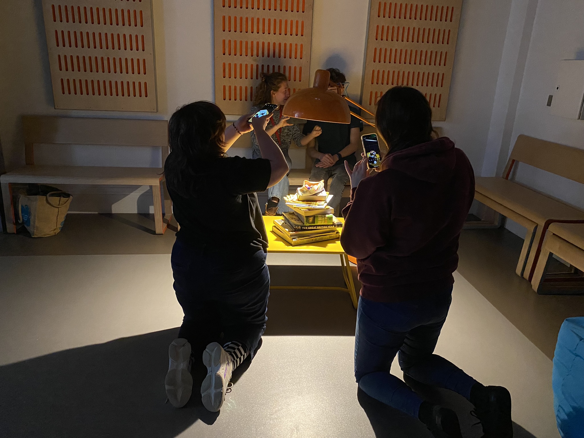 Young people photographing objects as part of task