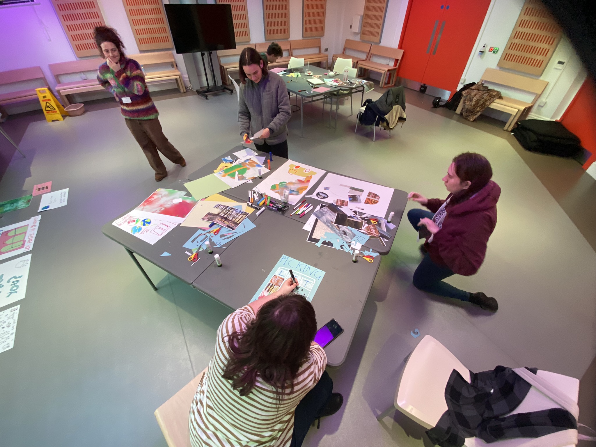 Young people working on poster designs as part of project