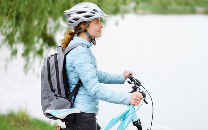 Woman Cycling By A River